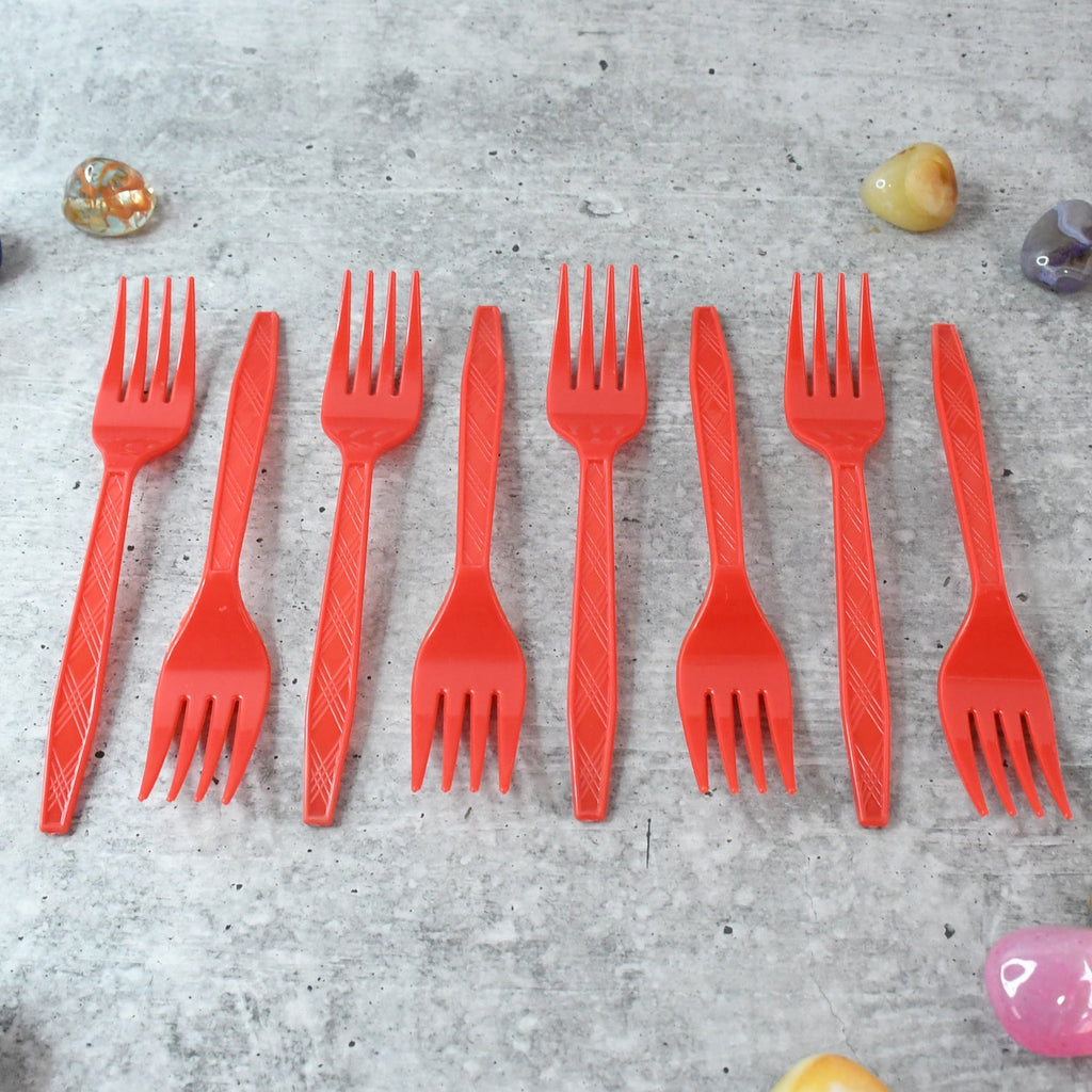 Stacked red disposable forks showing compact, portable design