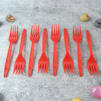 Stacked red disposable forks showing compact, portable design