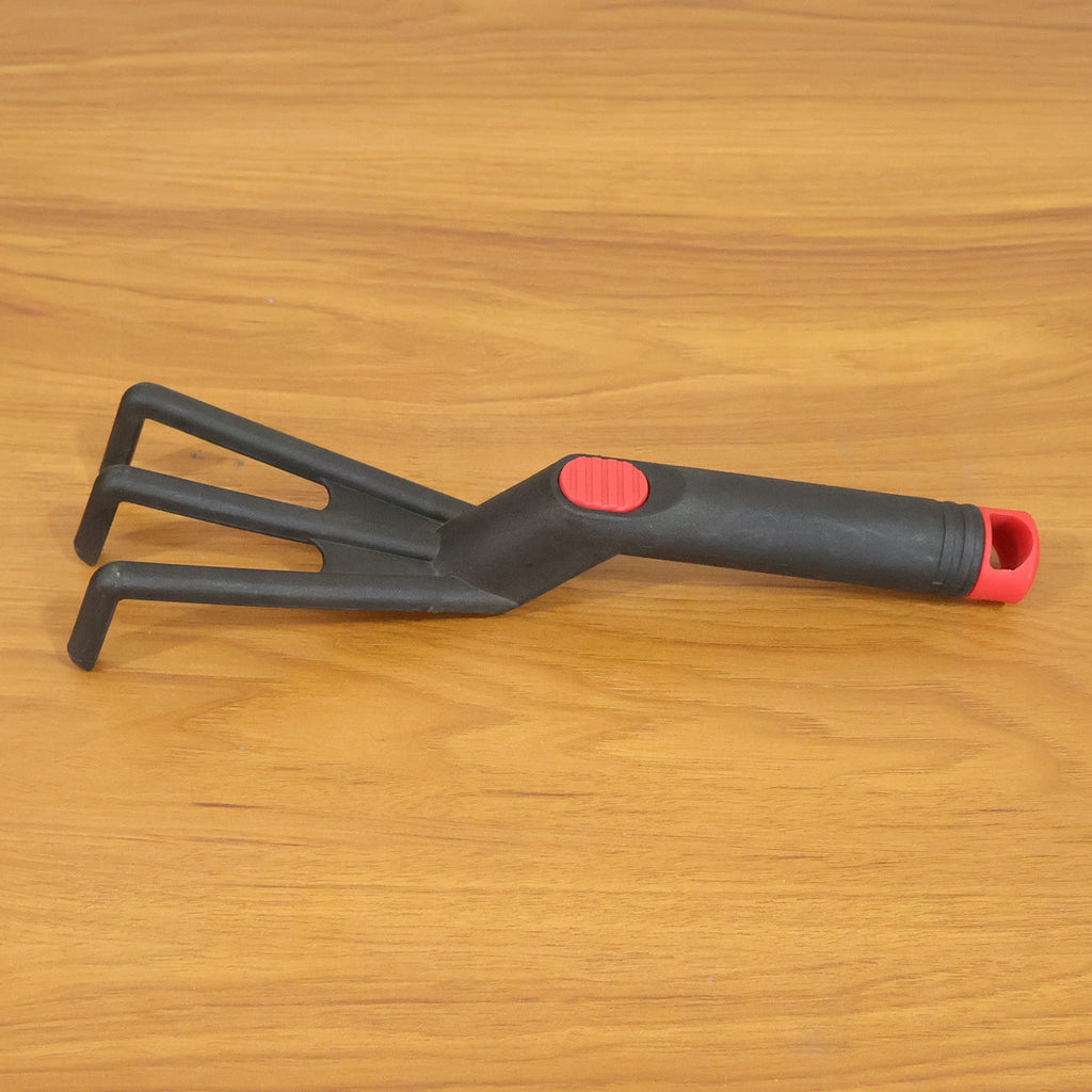 Garden maintenance with plastic hand garden cultivator