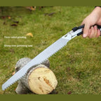 Effective hand pruning saw cutting a tree branch in a garden.