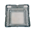 The elegant square glass ashtray displayed in a home or office setting.