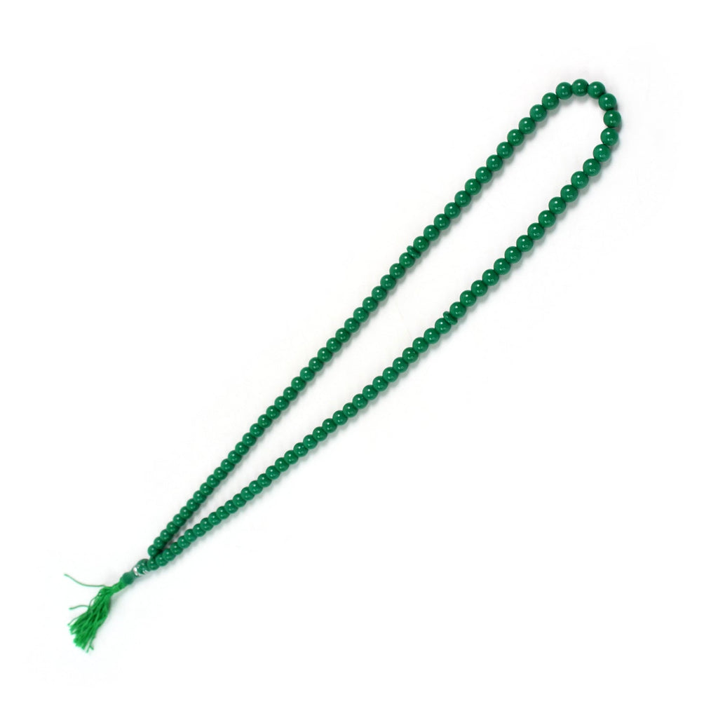A beautiful 99-bead tasbih draped gracefully on a serene surface.