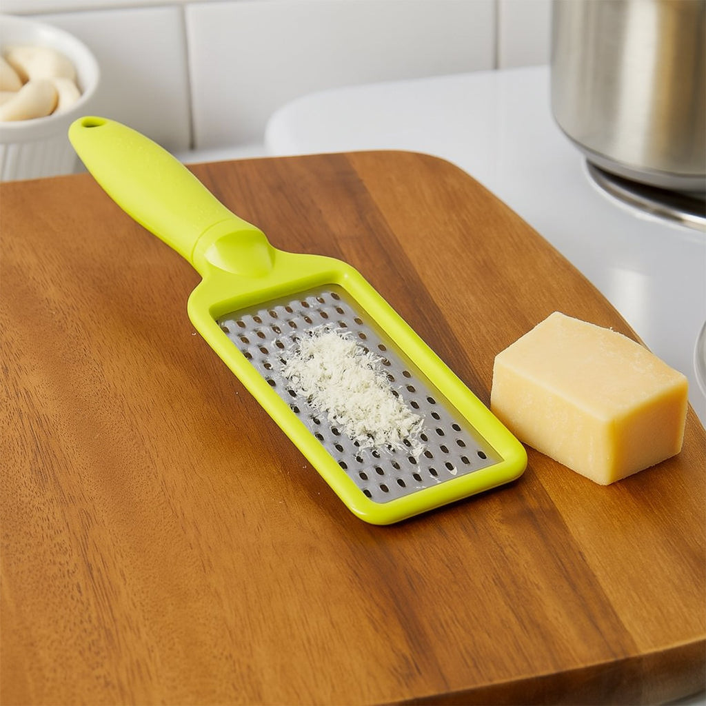 An overhead view of the CookAura grater, highlighting its full length and stainless steel blade.