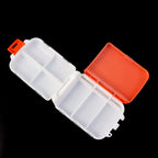Side view of plastic travel pill case displaying slim design