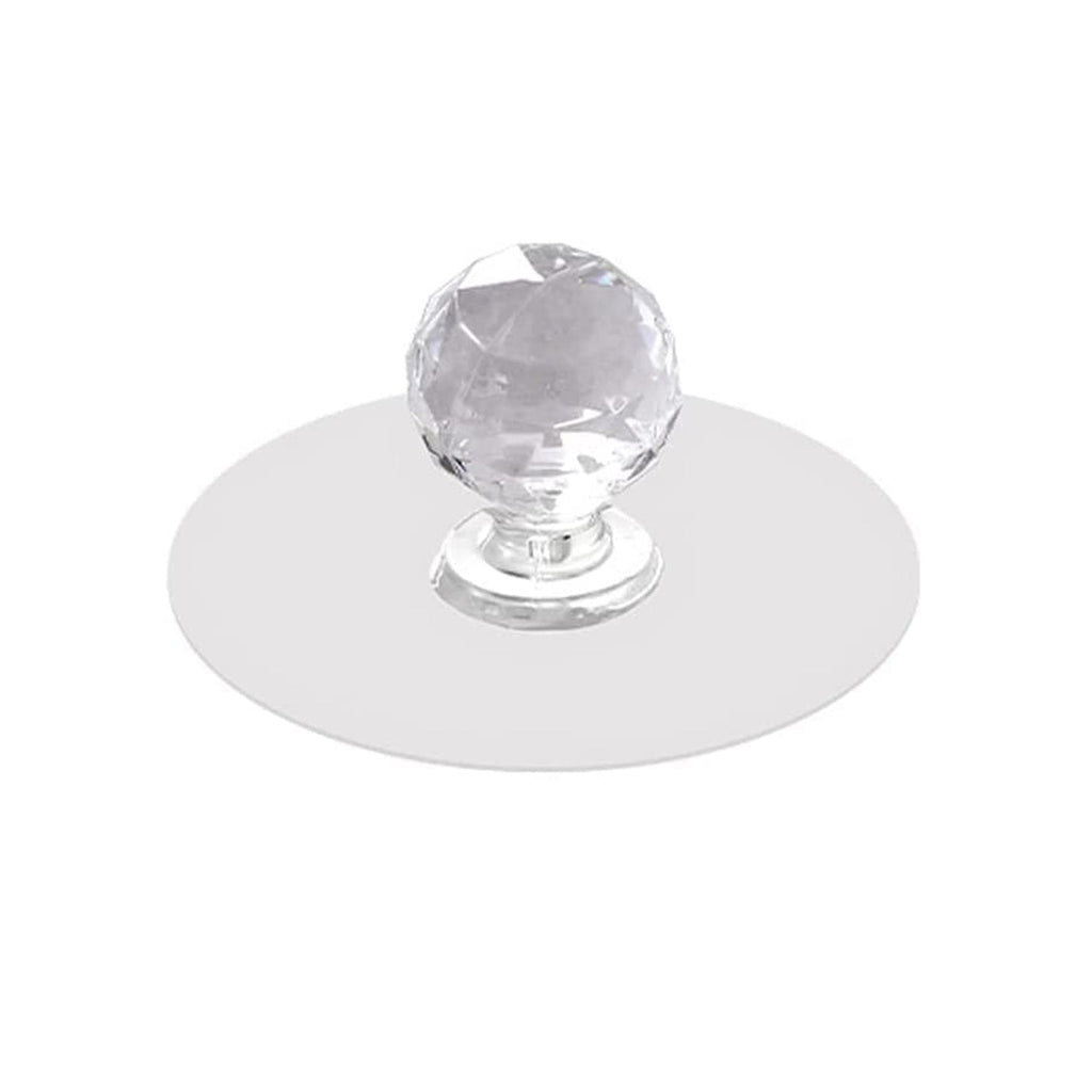 Crystal cabinet knob elegantly installed on a light wooden drawer for a modern look.