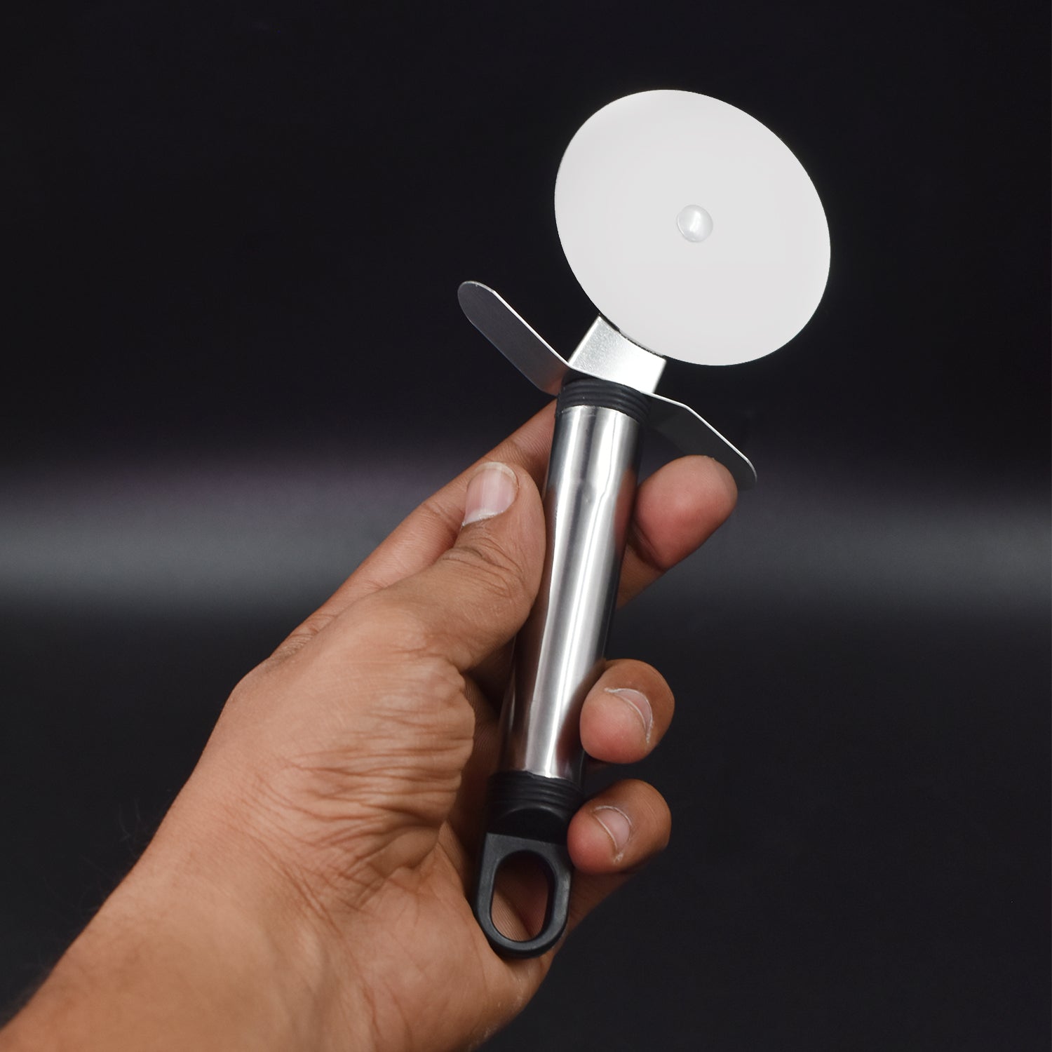 Wheel-type pastry and pizza slicer with a protective thumb guard.