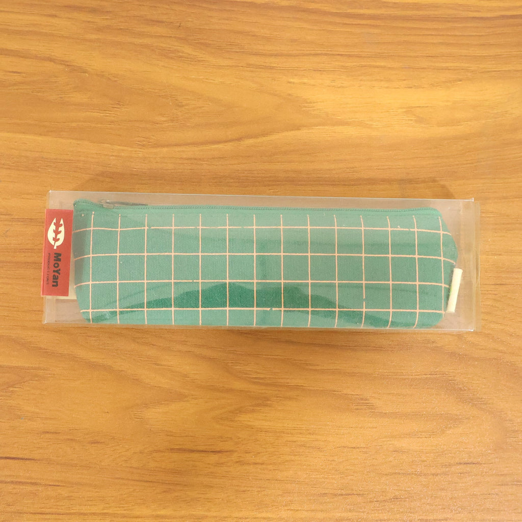 Close-up of high-quality fabric and grid pattern on the green pouch.