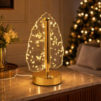 Festive decoration featuring golden crystal leaf LED table lamp on wooden surface