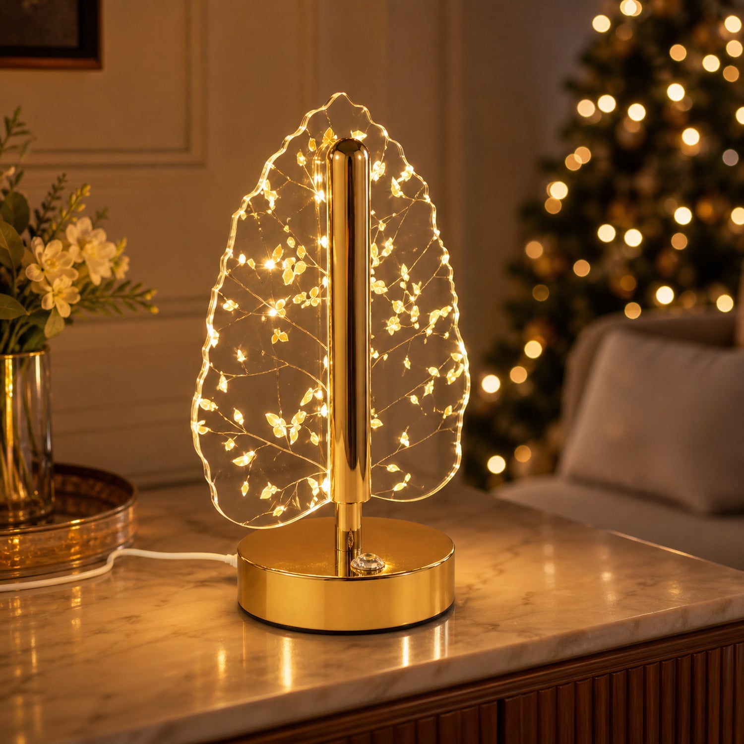 Festive decoration featuring golden crystal leaf LED table lamp on wooden surface