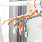 Foldable clothes hanger with adjustable arms extended
