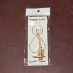 Different angle view of the golden Shivling metal keychain showcasing design