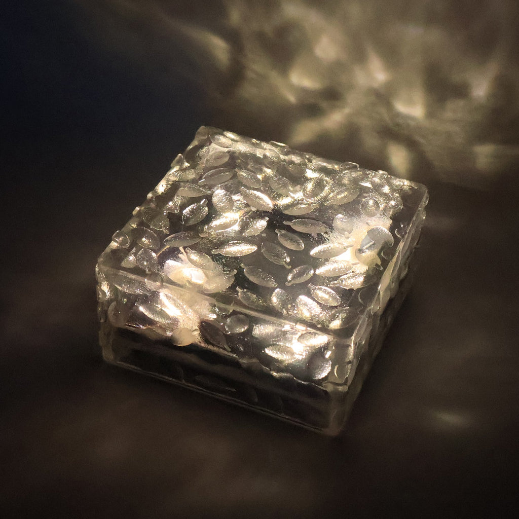 Close-up of a waterproof solar garden light, showcasing its frosted glass texture.