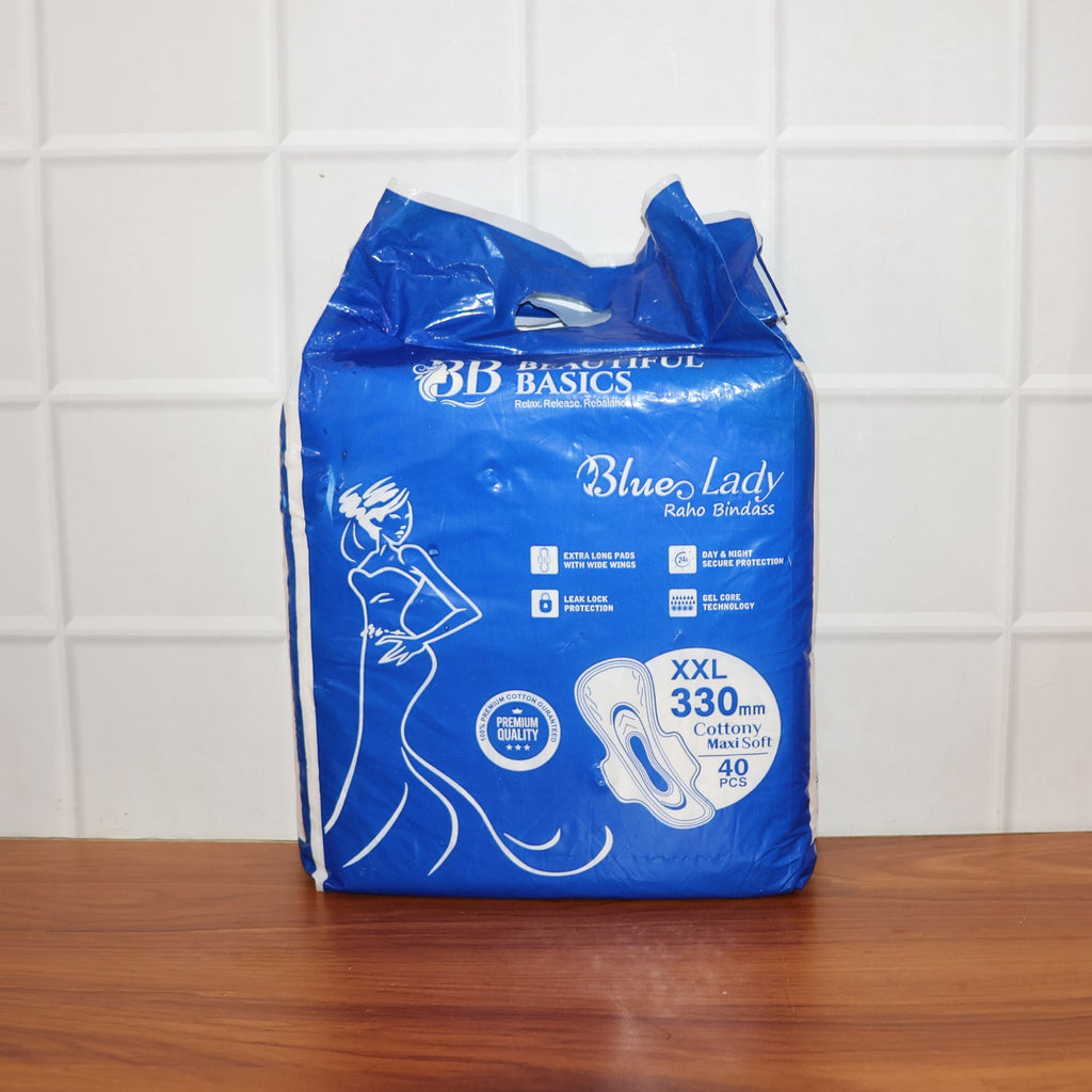 A pack of  Sanitary Pads 330mm next to a single pad, showcasing both the product and its packaging.