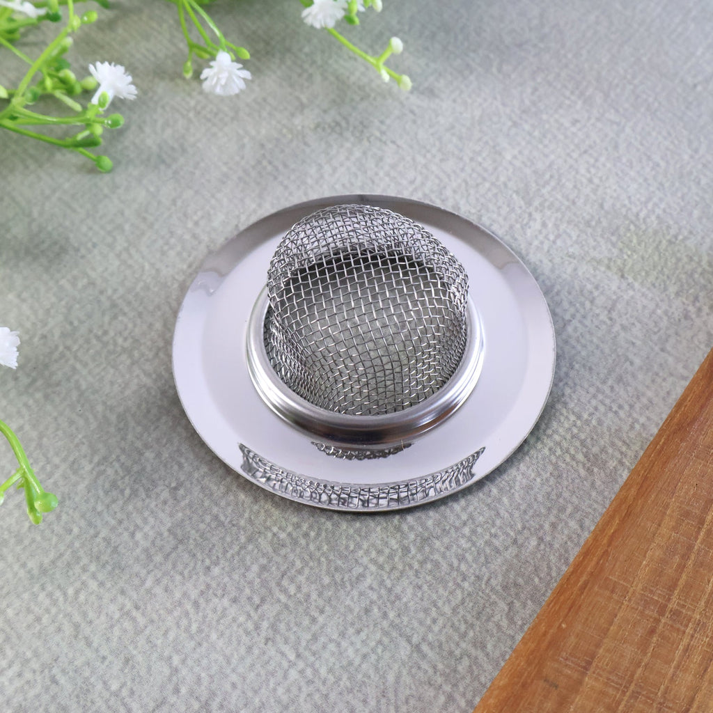 Kitchen sink drain hole protected by stainless steel strainer basket