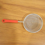 Kitchen strainer in use during cooking and food preparation