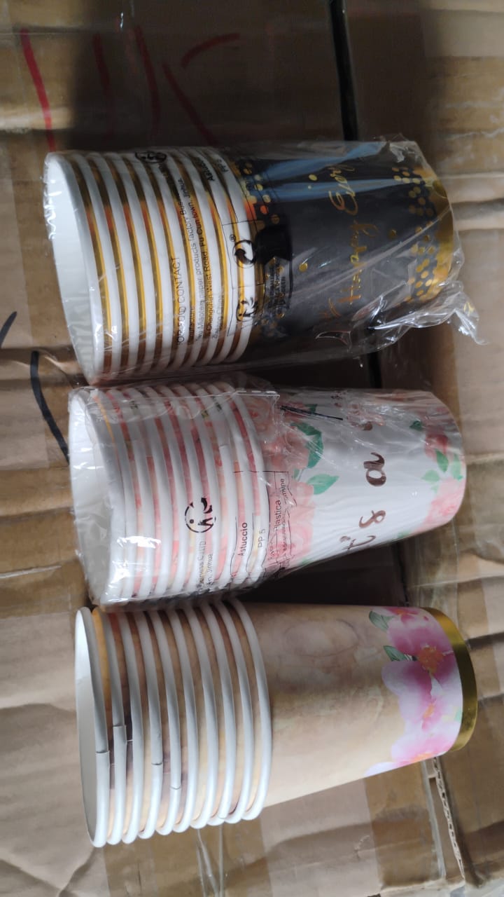 Mixed-design disposable paper cups stacked neatly, convenient for storage.