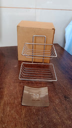 Sleek stainless steel self-adhesive wall mounted soap dish with integrated hooks.