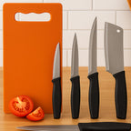 Tempered stainless steel kitchen knives next to plastic chopping board