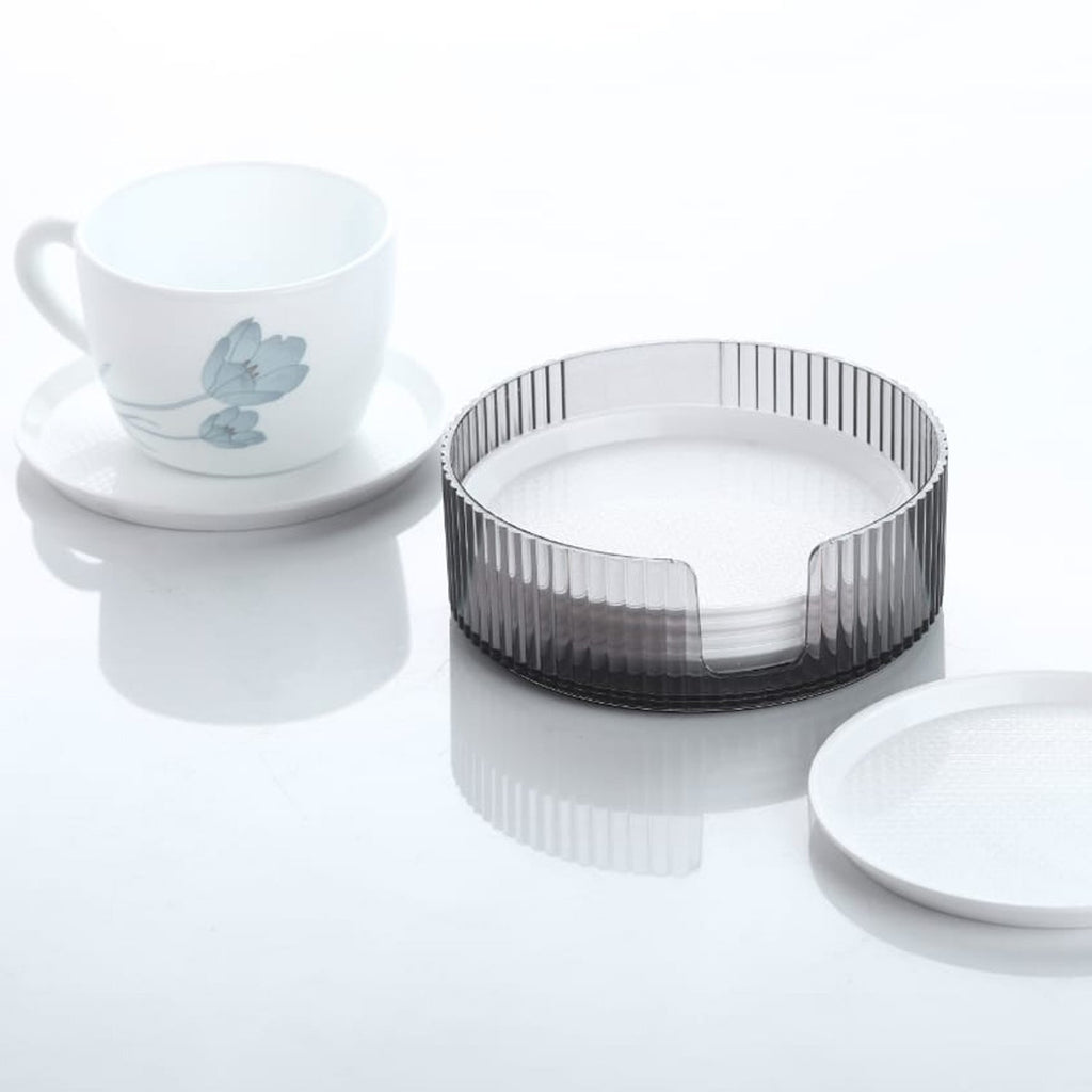 Elegant plastic coaster set designed to prevent unsightly water rings on tabletops.