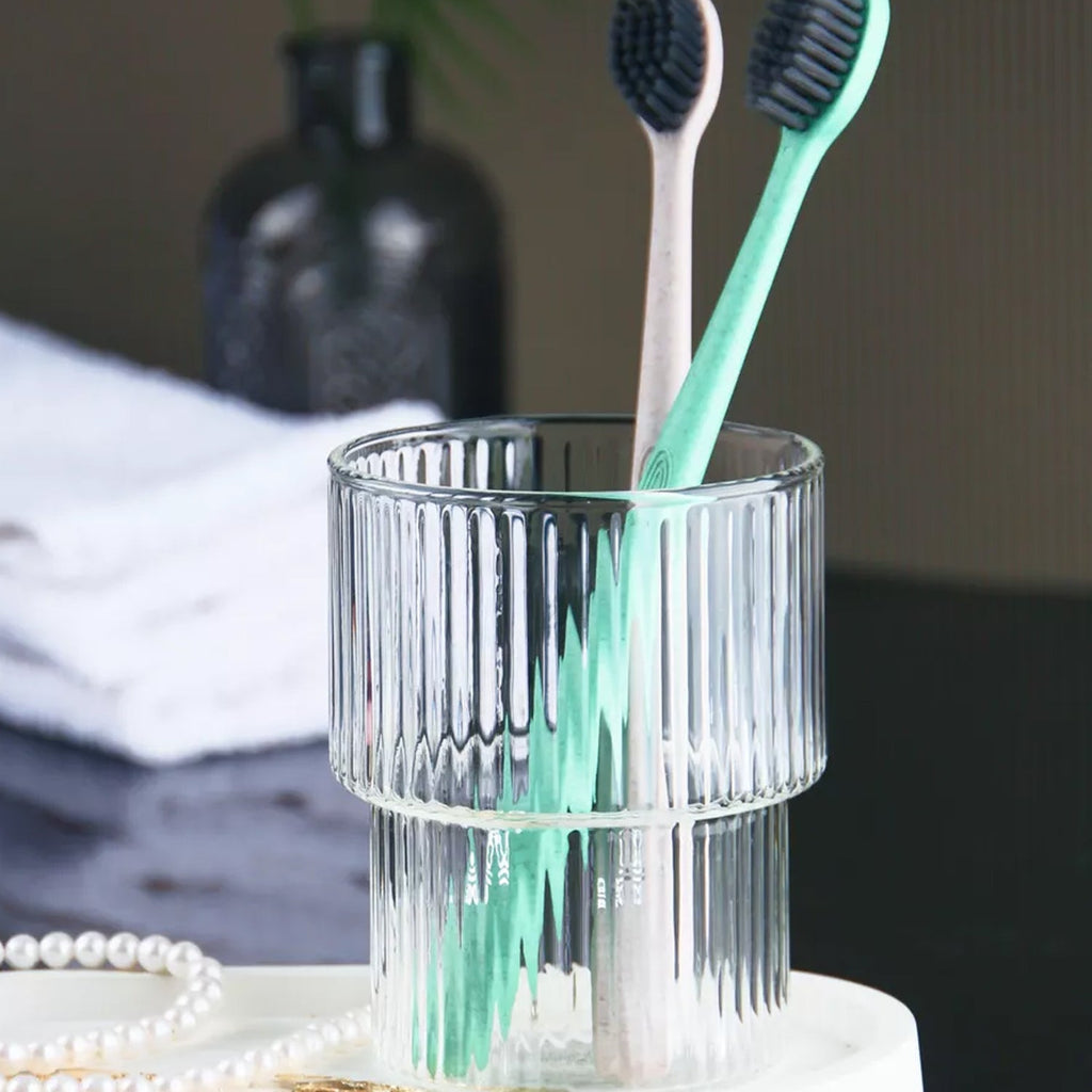 Toothbrush organizer tray with divided slots for brushes and grooming tools