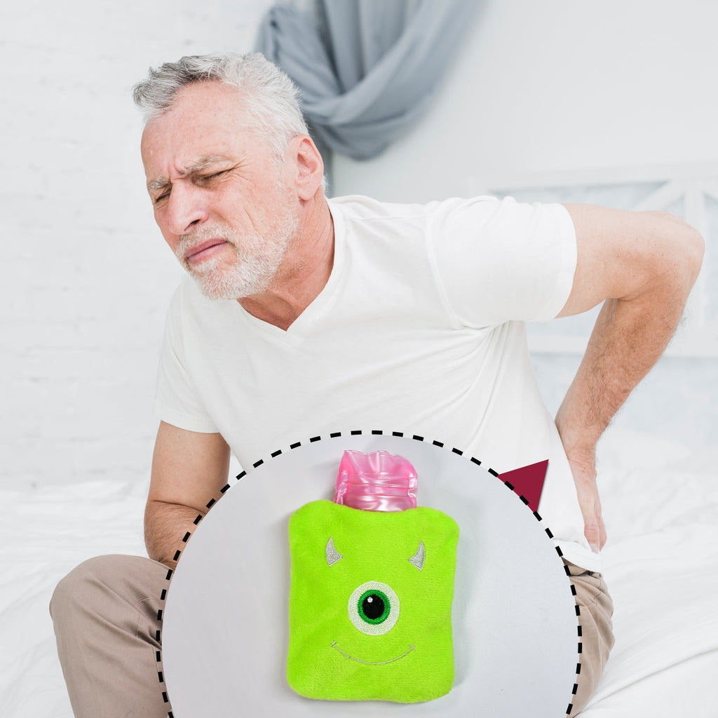 Monster print hot water bag being used on a shoulder for targeted pain relief.