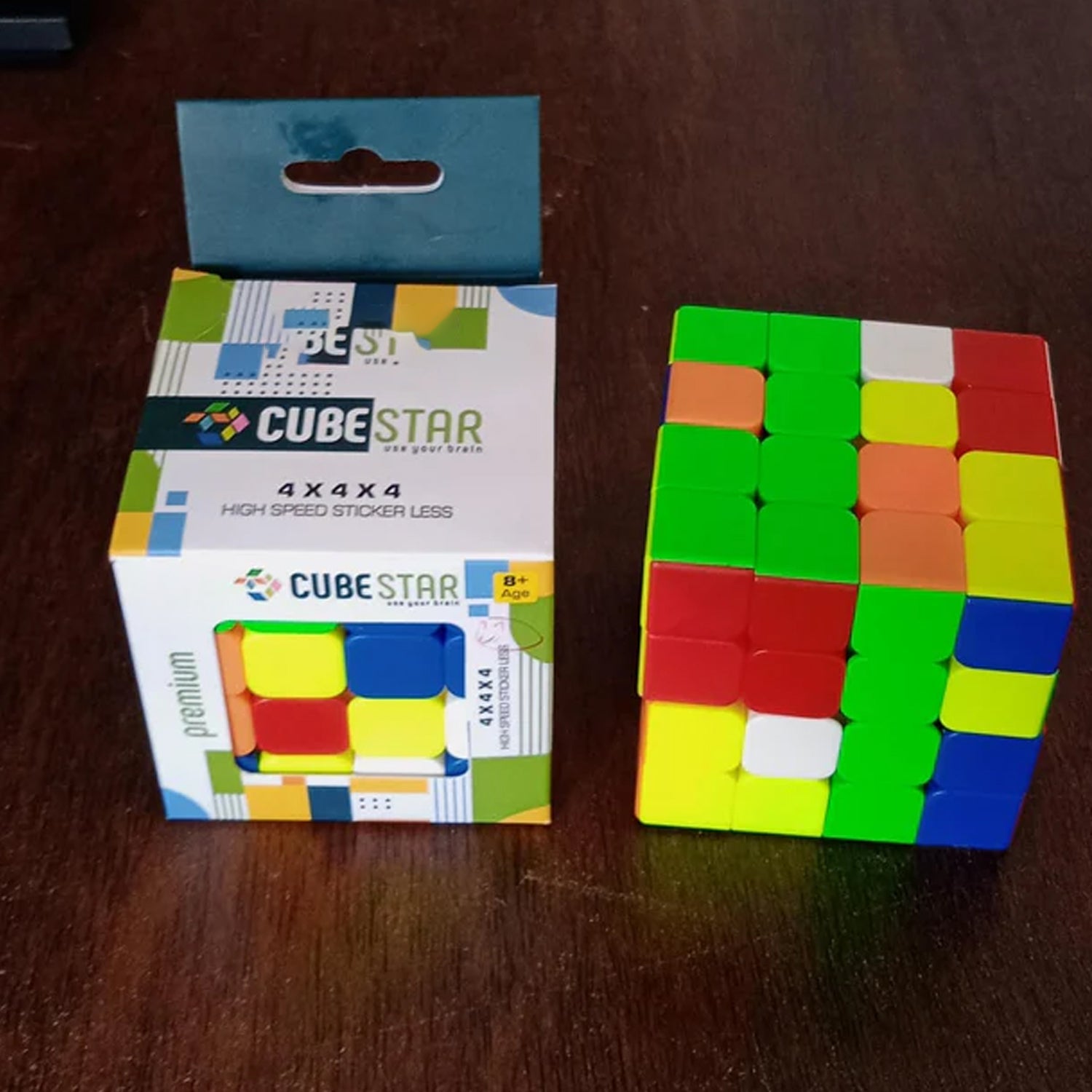 Close-up of the 4x4x4 magic cube's individual colourful faces and plastic quality.