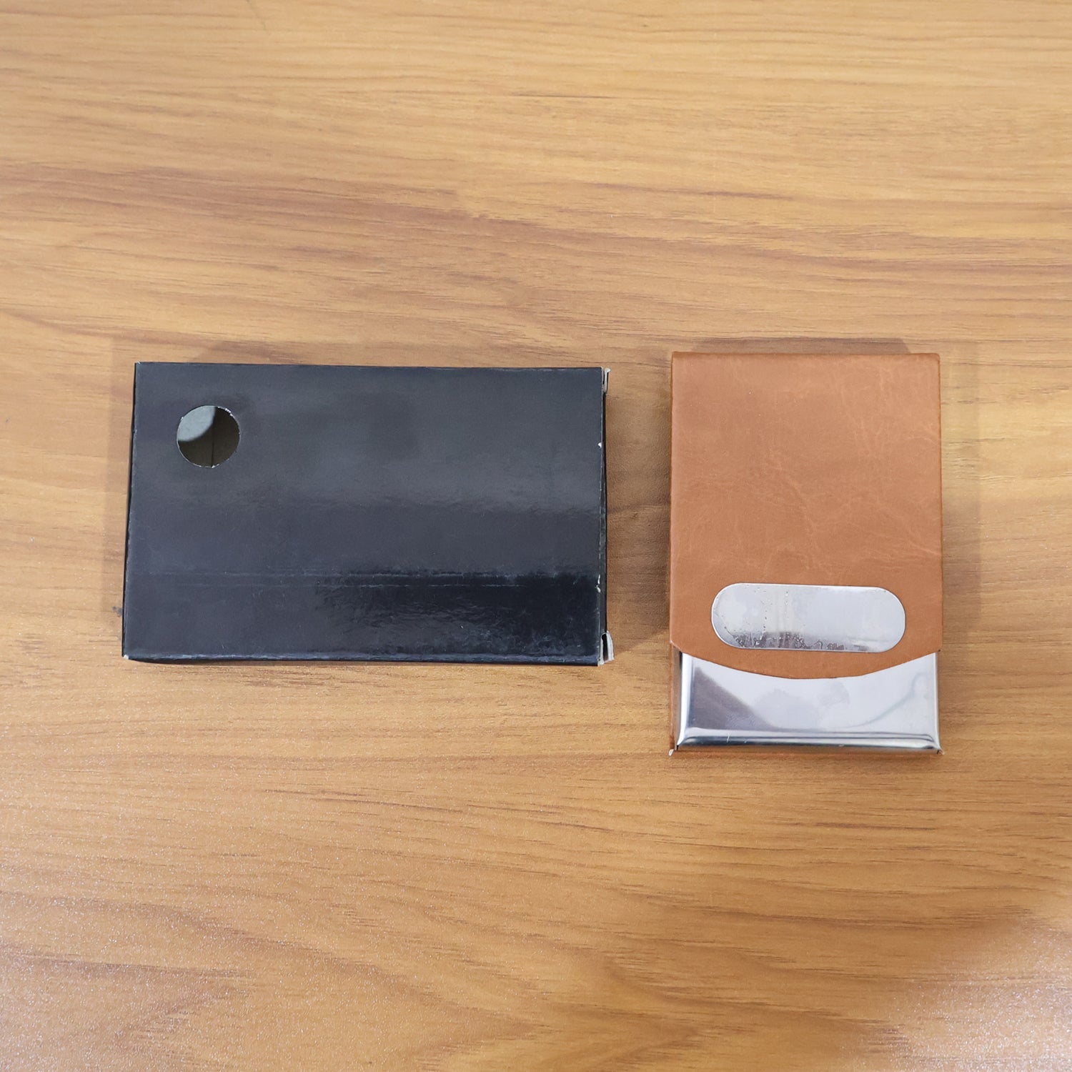 Display of premium leather business card holder with slide-out steel case