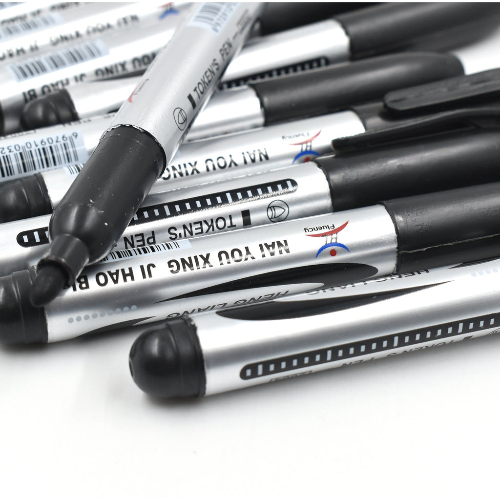 Hand holding an InkGlow Permanent Black Marker for smooth writing.
