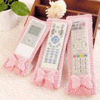 A decorative remote control cover with a bow knot, providing dust protection for TV remotes.