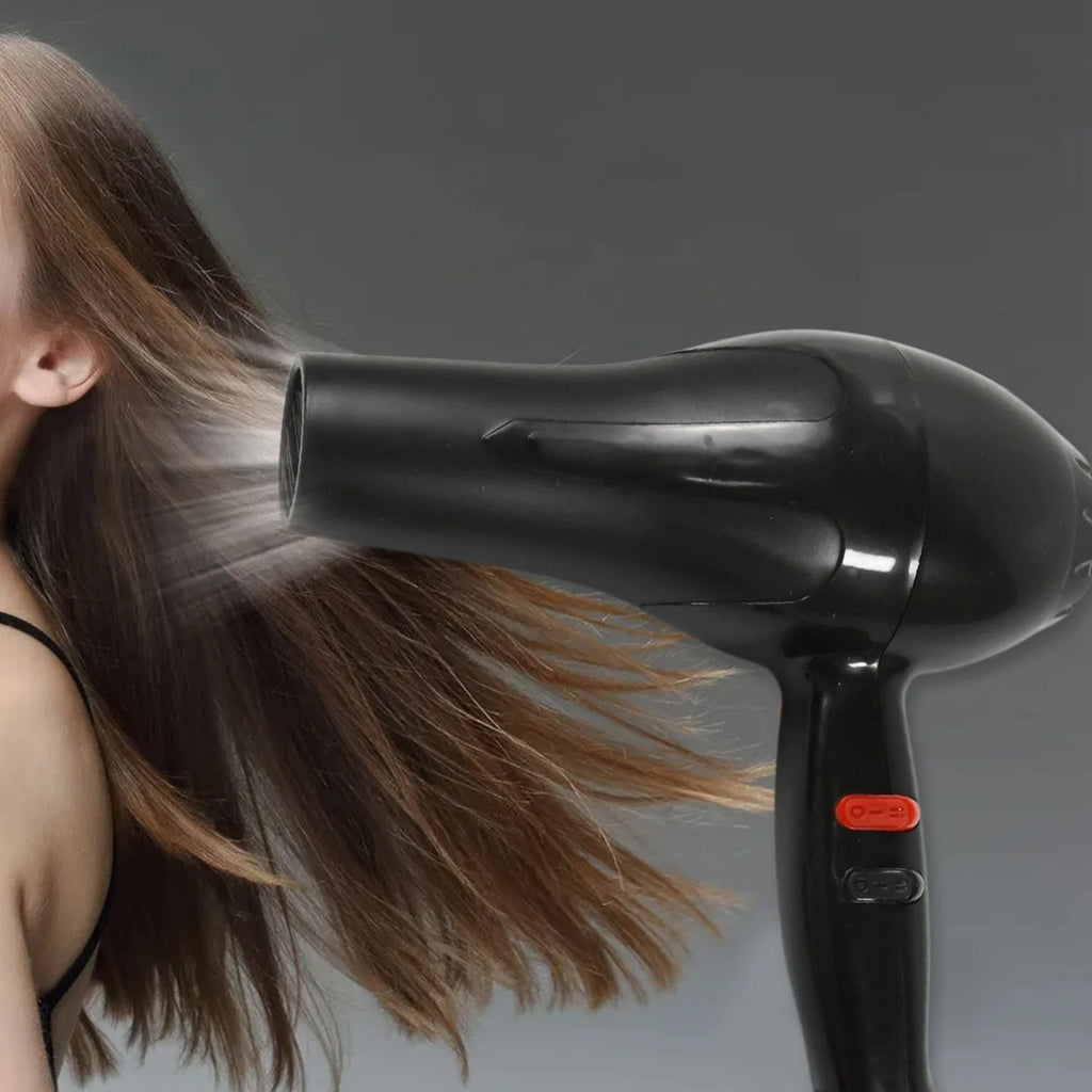 Hair dryer in action, creating a sleek hairstyle for Indian hair.