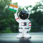 Solar powered astronaut ornament with Indian flag waving hand on car dashboard