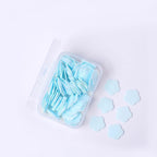 Detailed view of flower-shaped soap sheets beginning to dissolve in water.