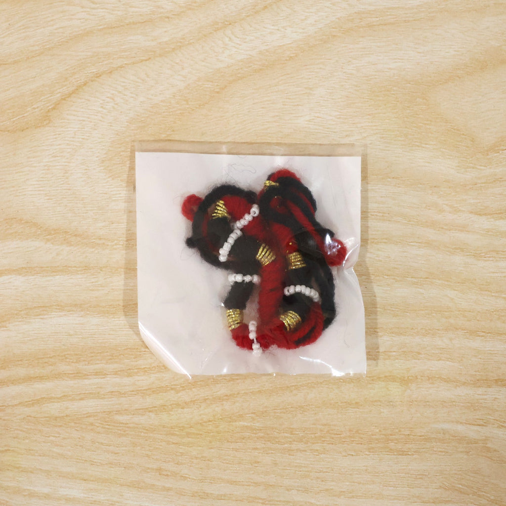 Festive red and black thread rakhi for brother with golden accents
