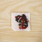 Festive red and black thread rakhi for brother with golden accents