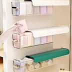 A 5-cell clear plastic wall mount drawer organizer holding socks in a closet.