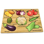 Child learning to place a wooden tomato piece into the vegetable puzzle board.