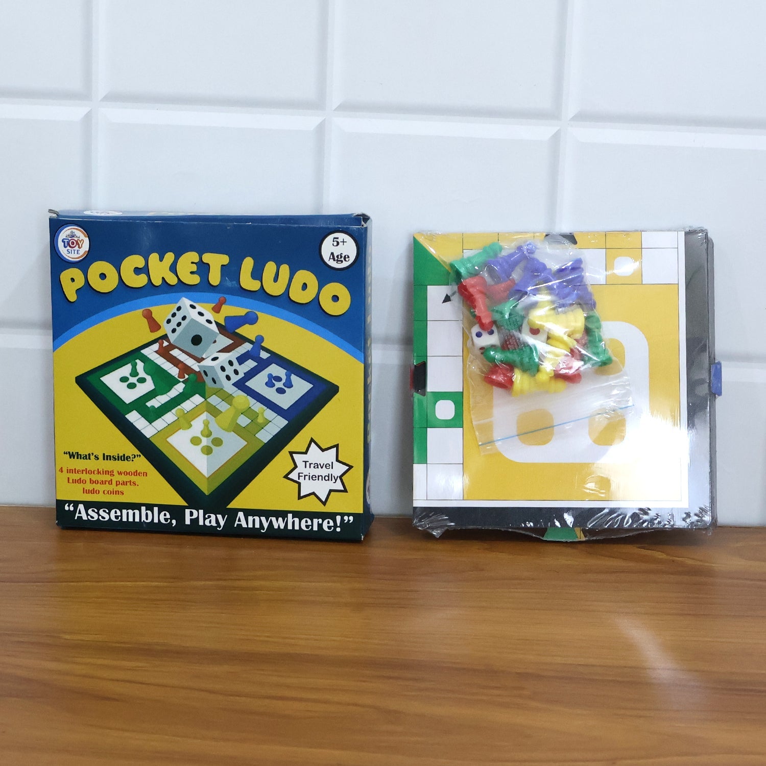Family enjoying a fun game night at home with the Pocket Ludo travel set.