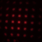 A galaxy projector creating a romantic starry night effect in a dimly lit room.
