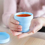 Ergonomic foldable silicone travel cup for comfortable sipping.