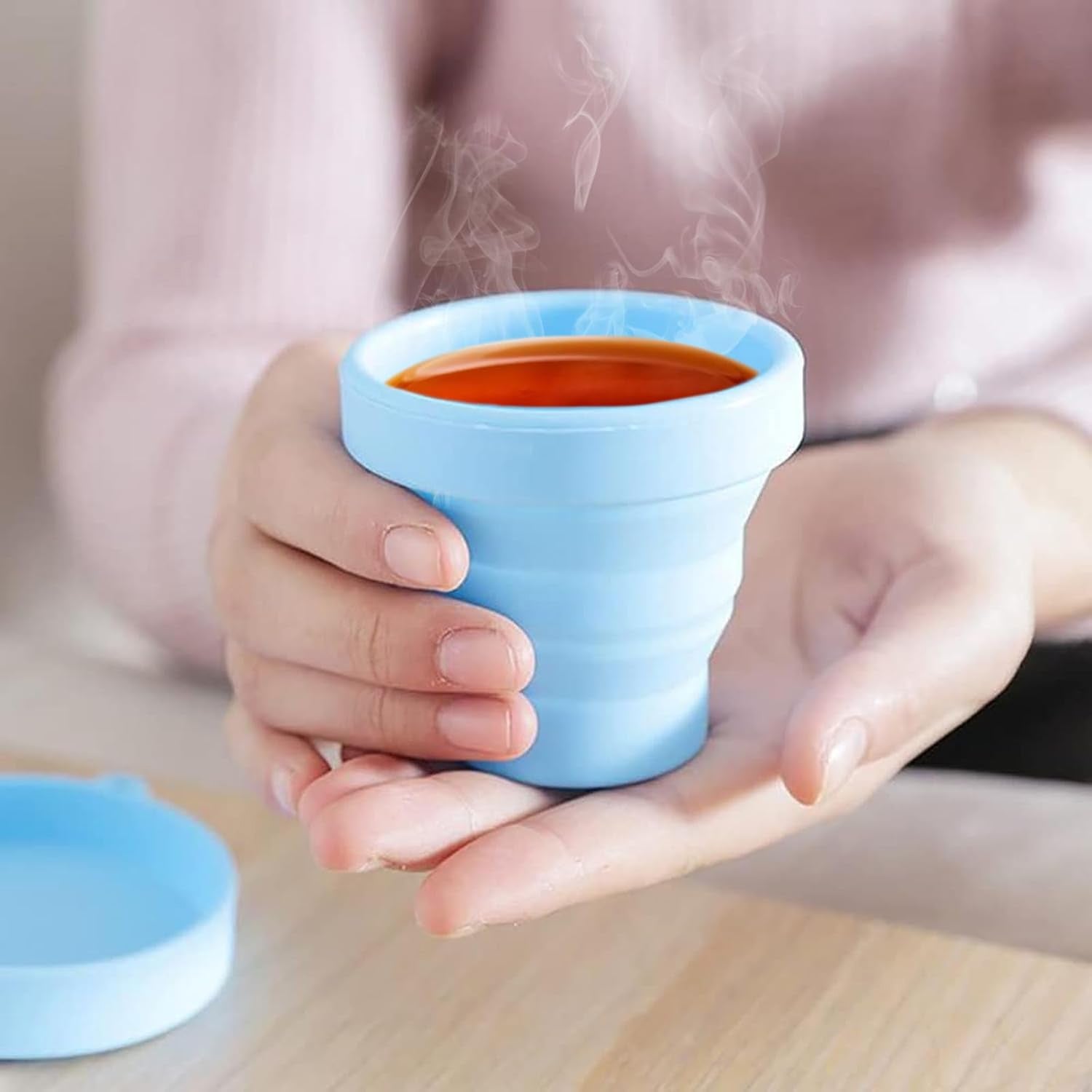 Ergonomic foldable silicone travel cup for comfortable sipping.