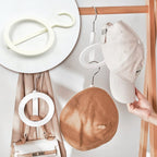 Multi-purpose Closet Organizer Hanger for neatly storing hats, scarves, and bags.