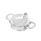 Set of stainless steel dumpling maker and accompanying dough cutter.