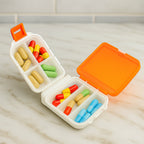 Closed dual-sided pill organizer box showing compact size