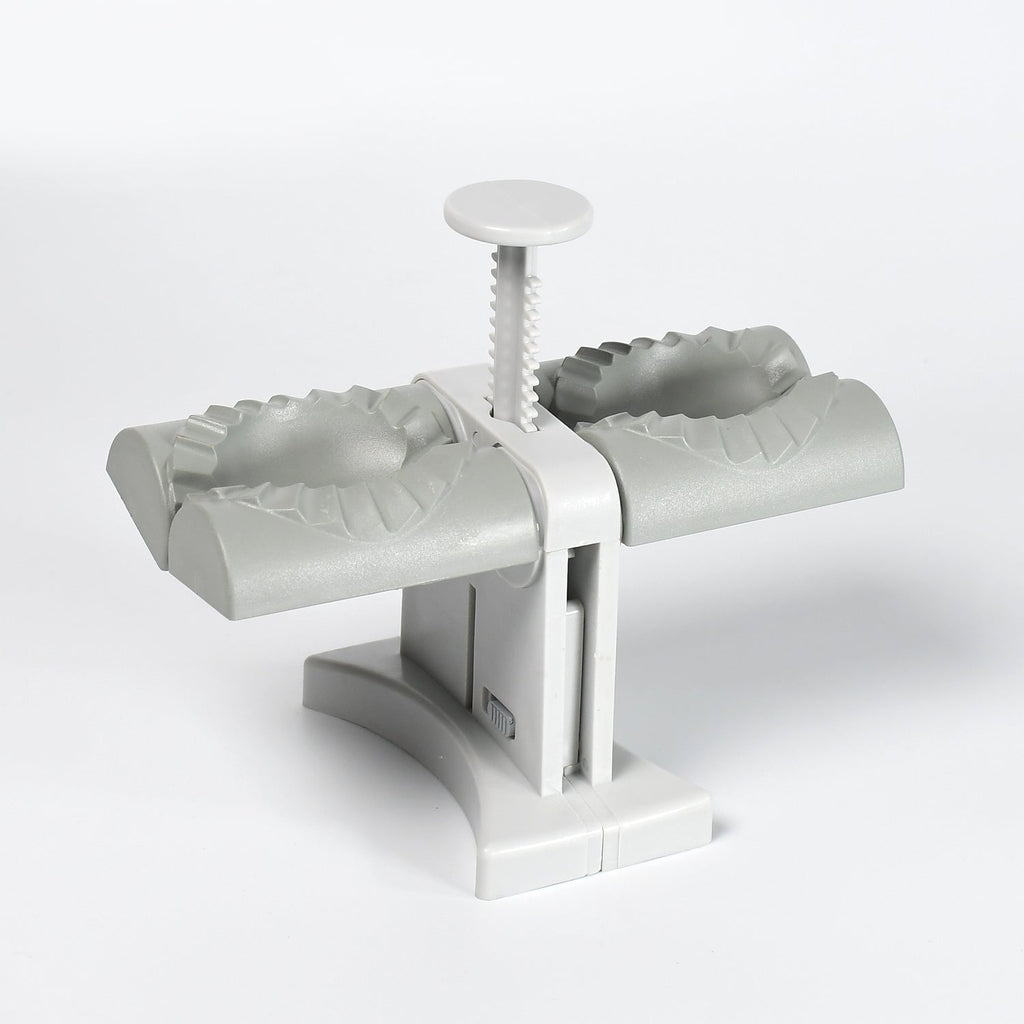 The double head dumpling maker mold displayed on a kitchen counter, ready for use.