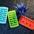 Top view of open ice trays showing ice cubes inside
