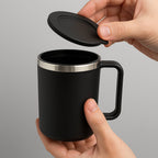 Detail shot of the insulated coffee mug's comfortable handle and sturdy construction.