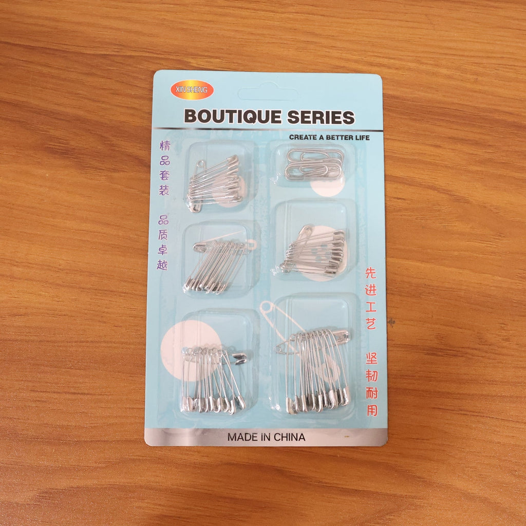 Organized set of rust-resistant metal safety pins in various sizes
