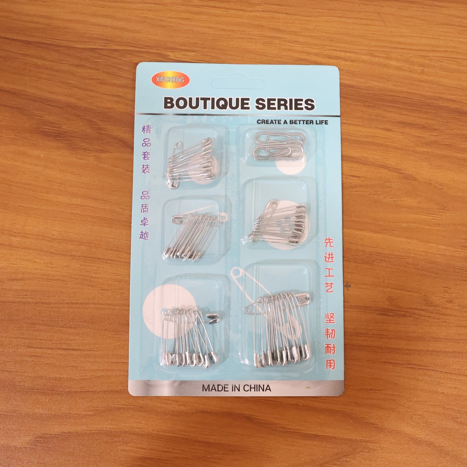 Organized set of rust-resistant metal safety pins in various sizes