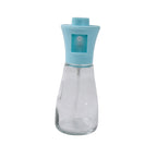 Transparent glass oil sprayer bottle showcasing its durable plastic top and sleek design.