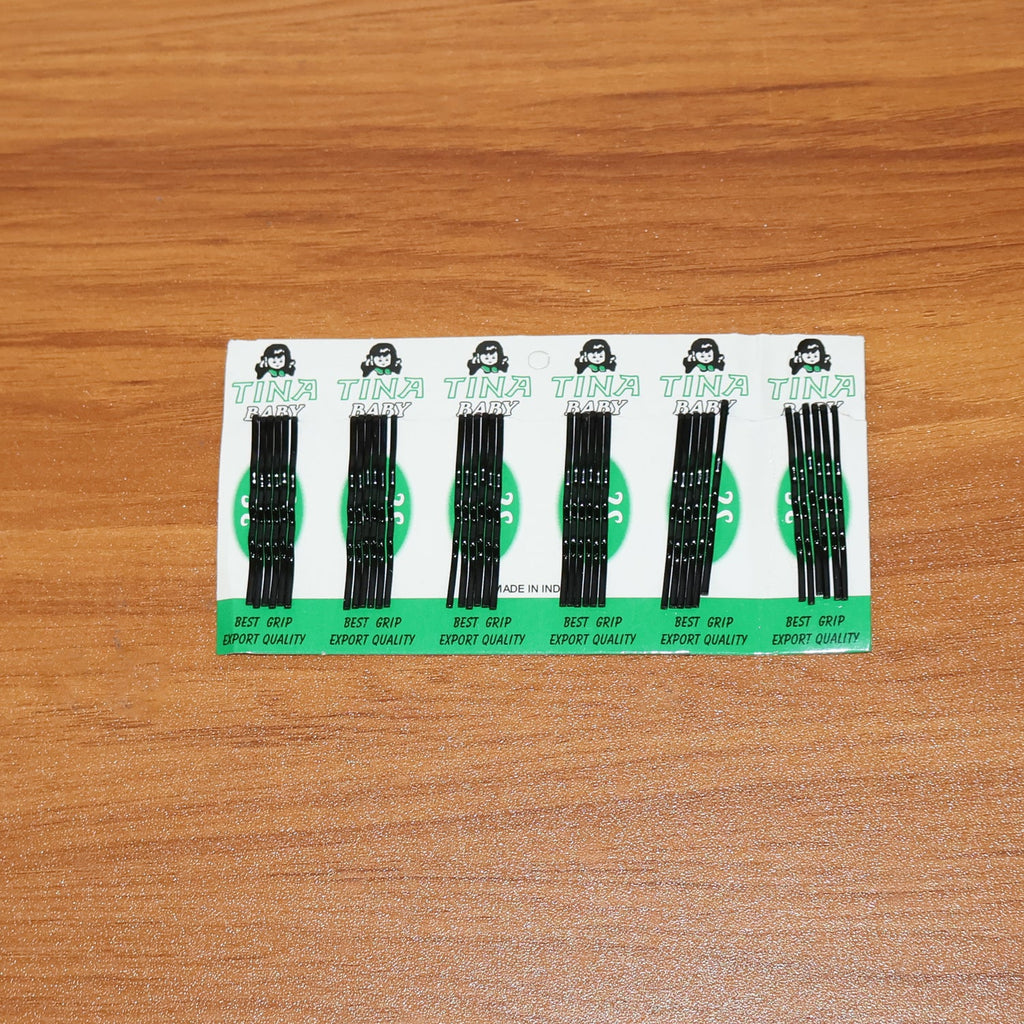 Black hair pins laid out for easy access during hair styling